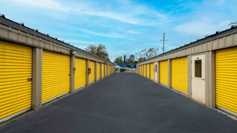 Storage units with yellow doors. Drive up access, wide lanes, outdoor option. Devon Self Storage - Stage Coach Trail in Greensboro, NC