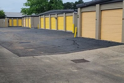 Drive up storage, yellow storge unit doors. Wide lanes for unpacking or packing storage items.