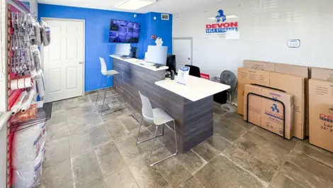 Office area at storage facility surrounded by storage supplies at Devon Self Storage - Ingram Road in San Antonio, TX