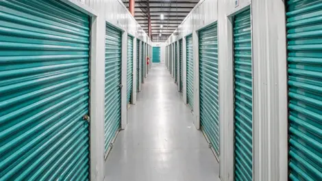 Inside view of storage units. Hallway, clean and storage doors a turquoise blue. Devon Self Storage 5961 Interstate in Jackson, MS.