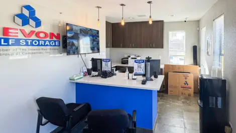 Office area with security view on the wall, plus moving, storage boxes at Devon Self Storage - Perrin in San Antonio, TX