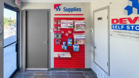 Entry area with wall of moving, packing & storage supplies at Devon Self Storage - Perrin in San Antonio, TX