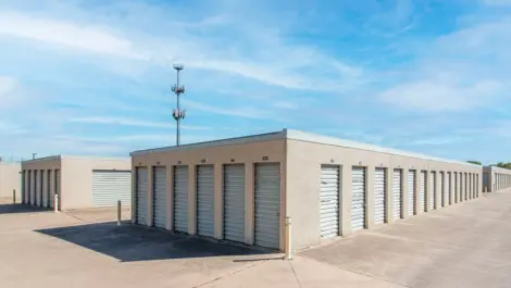Exterior view of small unis, drive up access and outdoor storage at Devon Self Storage - Loop 410 in San Antonio, TX