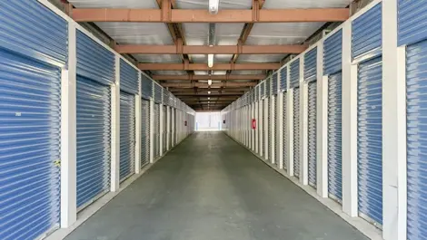 Medium size storage units with blue doors with wide hallway in Hendersonville, TN, at Devon Self Storage - Shackle Island