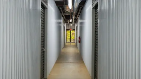 Grey walls inside Devon Self Storage - Peachtree Corners, Grey doors to storage units. View of entrance and exit.