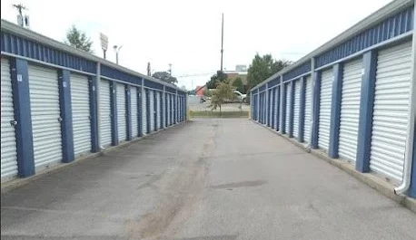 Devon Self Storage - Fort Campbell blue building with white doors, storage facility. Rows of units.