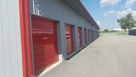 Devon Self Storage - Frankfort, drive up storage units, grey building with red storage doors