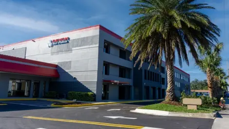 Exterior view with palm trees at Devon Self Storage in Holly Hill, FL,
