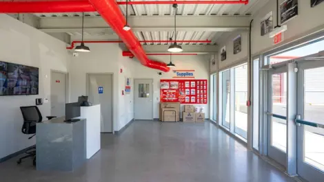 Devon Self Storage - Admiral Wilson, NJ office area with tv for security and wall of storage supplies