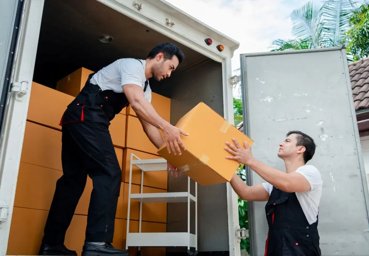 Movers moving boxes on a truck