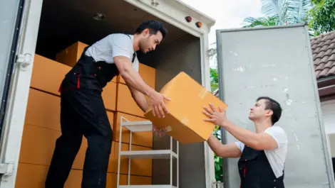 Movers moving boxes on a truck