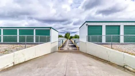 Devon Self-Storage - Lake Orion, view of drive way leading to drive up storage options, green doors
