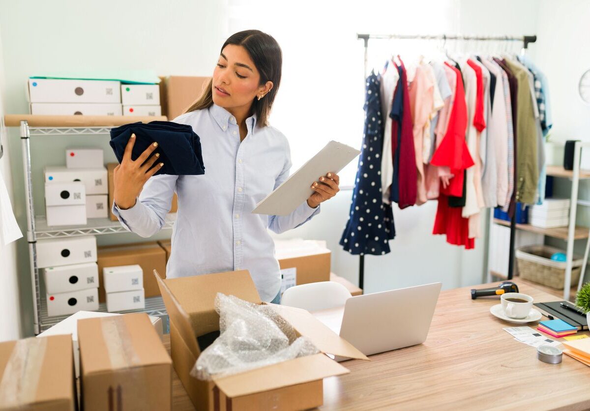 A woman manages her small business from her cluttered home office.