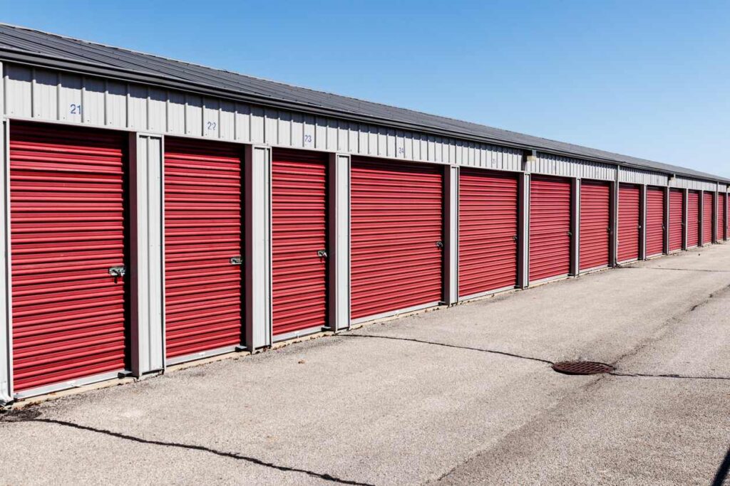 A line of self storage units of varying sizes at a drive-up storage facility.